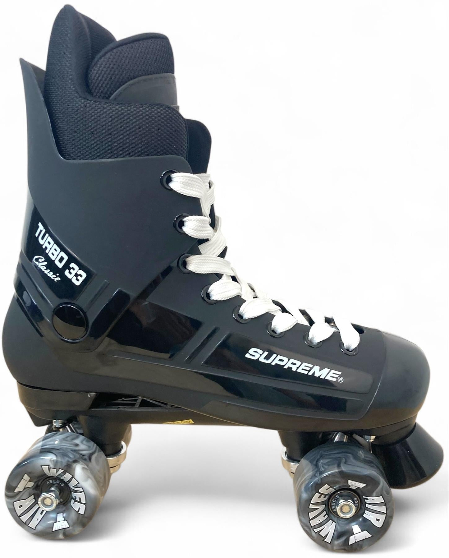 The Supreme Turbo 33 Nylon Quad Roller Skates in black, with bold “Supreme Turbo 33” branding and black swirl wheels, are set against a clean white background.