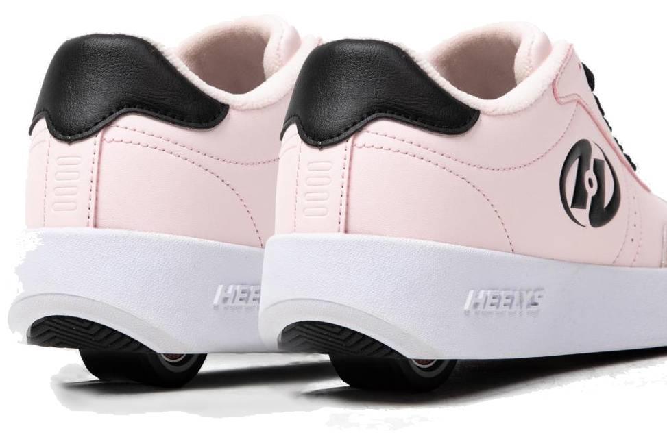 A pair of Heelys Goleeh Girls Shoes in blush pink with black accents, featuring built-in wheels and a black circular logo on the side, viewed from the back and slightly to the side. Brand: Heelys.