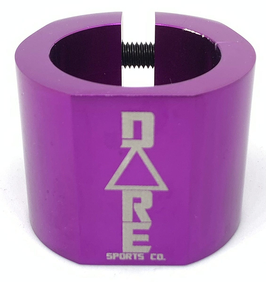 The Dare Warlord 2 Bolt Standard Stunt Scooter Clamp in purple is CNC machined for precision and includes a slot and a threaded bolt. This lightweight clamp features the Dare logo, which showcases a triangle with "DRE" above "Sports Co.