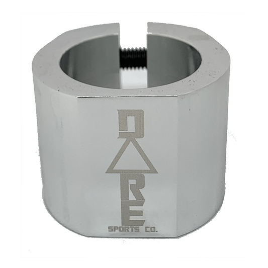 The Dare Warlord 2 Bolt Standard Stunt Scooter Clamp in chrome is depicted with a CNC machined finish and a hexagonal design. The clamp, made by Dare, has an engraved logo reading "DARE Sports Co." and features a visible screw on top for tightening or fastening. It is shown against a white background.