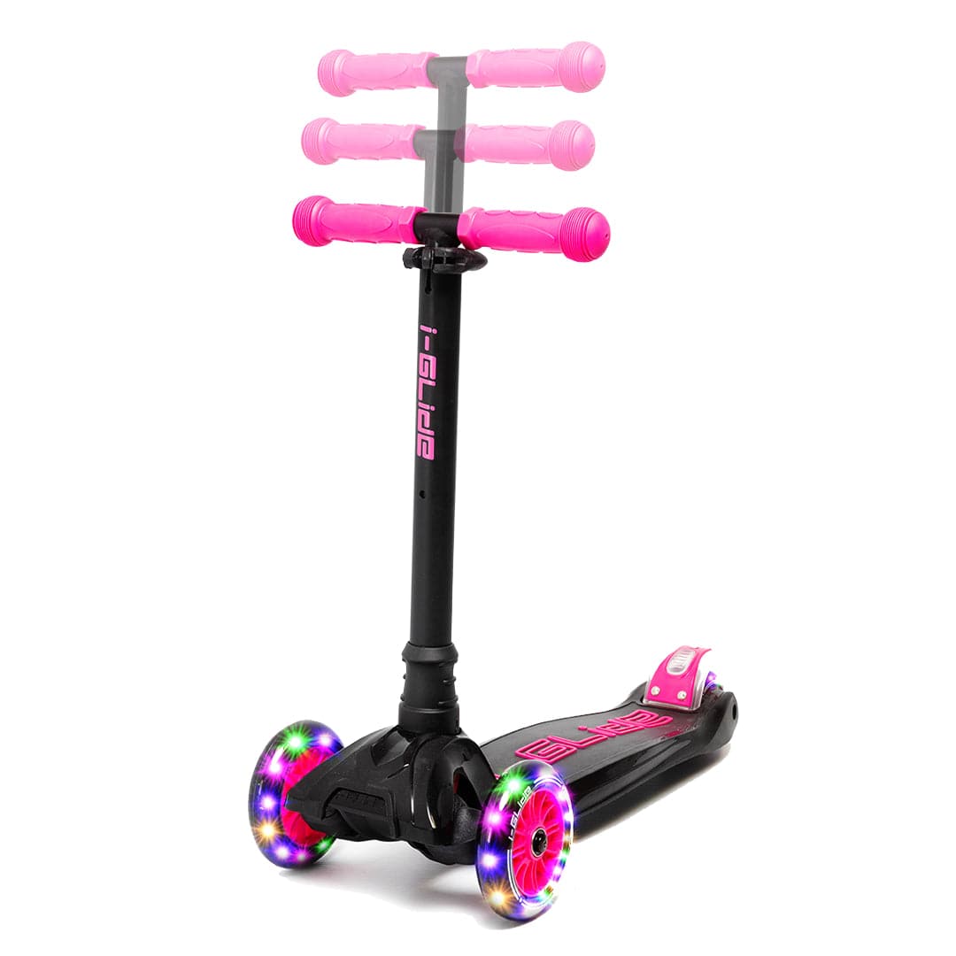 Introducing the I-Glide 3-Wheel LED Kids Scooter in Black/Pink, equipped with ezy-steer technology for smooth rides. It features three adjustable height handlebar levels and two front wheels adorned with colorful LED lights, along with pink accents on the deck and the I-Glide brand name.
