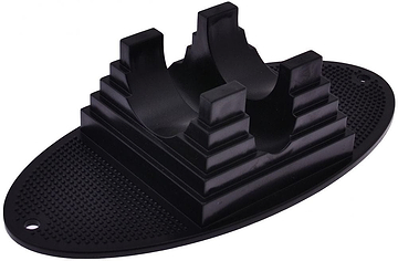 The Dial 911 Stunt Scooter Stand in black is an oval-shaped rubber pad with central pyramid structures, designed to hold items securely. It is ideal as a scooter stand, featuring a textured base and two holes on either end to ensure an upright position.