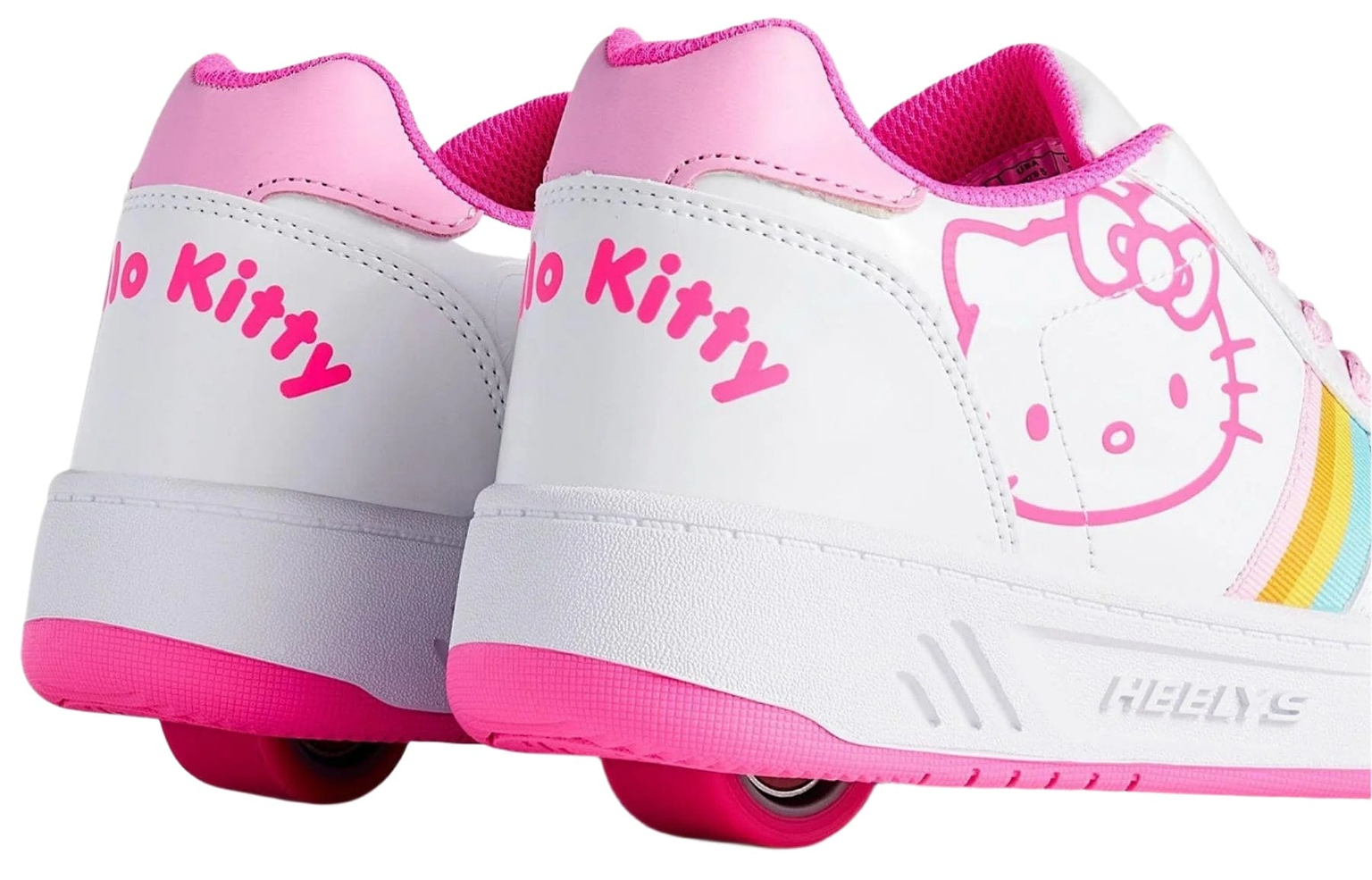 Close-up of Heelys x Hello Kitty Kama Girls Shoes in white and pink featuring built-in wheels, rainbow stripes, bright pink accents, and "Hello Kitty" printed on the sides for a playful Sanrio-inspired style. Brand: Heelys.