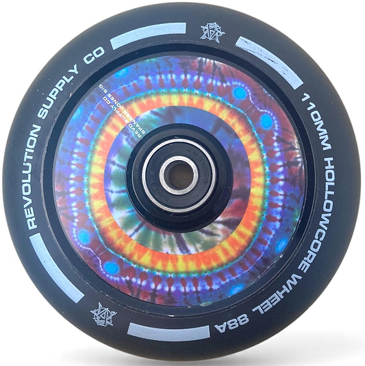 The Revolution Hollowcore 110mm Stunt Scooter Wheel – Spanner Jones Signature features a black core with vibrant tie-dye pattern, white logo accents, and smooth ABEC 9 bearings. Designed by Revolution for style and performance.