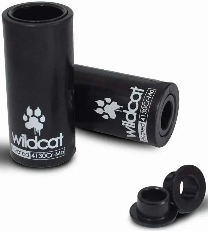 The Wildcat Pro Mini BMX Pegs - Black include two Chromoly pegs with Wildcat branding and a paw print, plus two small black adapters. Designed for bike axle installation, they're built for durability.