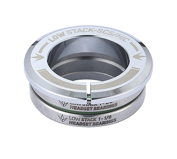 A Blunt Envy Low Stack SCS Integrated Stunt Scooter Headset bearing in chrome, featuring engraved text reading "LOW STACK 1-1/8" HEADSET BEARINGS." This bearing, crafted for a stunt scooter headset, presents a shiny silver finish with a grooved design and includes sealed bearings for enhanced durability.