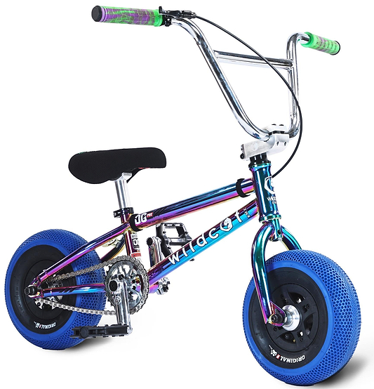 The Wildcat OG Pro Mini BMX Bike - Joker Blue Neochrome features a compact metallic rainbow frame, thick blue turbo wheels, black seat and pedals, and green and purple handlebar grips. "Wildcat" is proudly displayed on the frame.