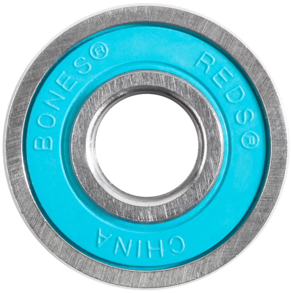 A close-up of a Bones REDS Big Balls Skateboard Bearing from the 16 Pack, featuring a metal outer ring and turquoise inner shield marked "BONES REDS CHINA," designed by Bones for speed and durability with its innovative six-ball construction.