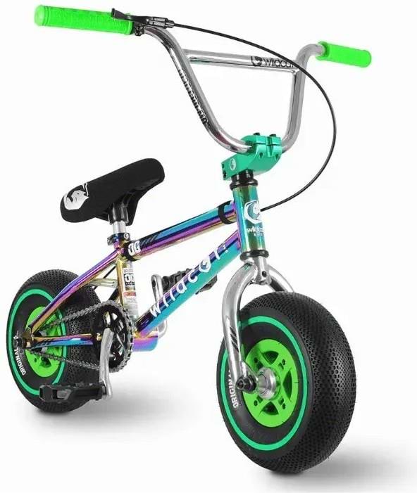 The Wildcat OG 3A Mini BMX Bike - Royal Green features a metallic rainbow frame, chromoly steel handlebars, green seat grips, a black seat, black tires with bright green rims, PRO Street 65PSI tyres, training pedals, and a sporty design.