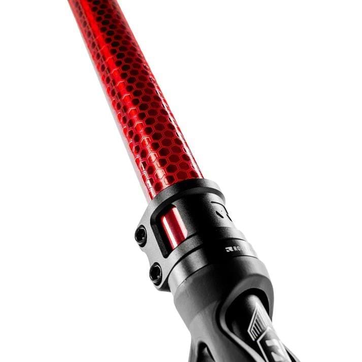 Close-up of a metallic burnt red rod with a hexagonal pattern, likely part of the Root Industries Invictus V3 Complete Stunt Scooter by Root Industries, attached to a black clamp, set against a white background.