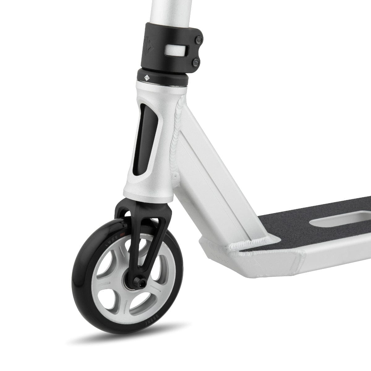 A close-up of the Drone Element 2 Feather-Light Complete Stunt Scooter in Silver Anodized highlights its front wheel and deck. The black Luxe 3 Dual-Core Wheel features stylish white spokes, and the deck is equipped with a textured grip surface. Its frame, with a sleek metallic finish, is accented by an IHC aluminum fork for smooth riding.