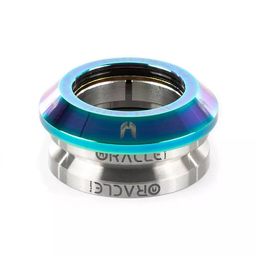 The Ethic DTC Oracle Integrated Stunt Scooter Headset in Neochrome features a metallic, smooth, slightly conical design. The upper section displays a gradient of blue and purple hues, while the lower part is silver with the "RACEFACE" engraving. This headset is built to withstand heavy landings, making it ideal for stunt scooter enthusiasts seeking durability.