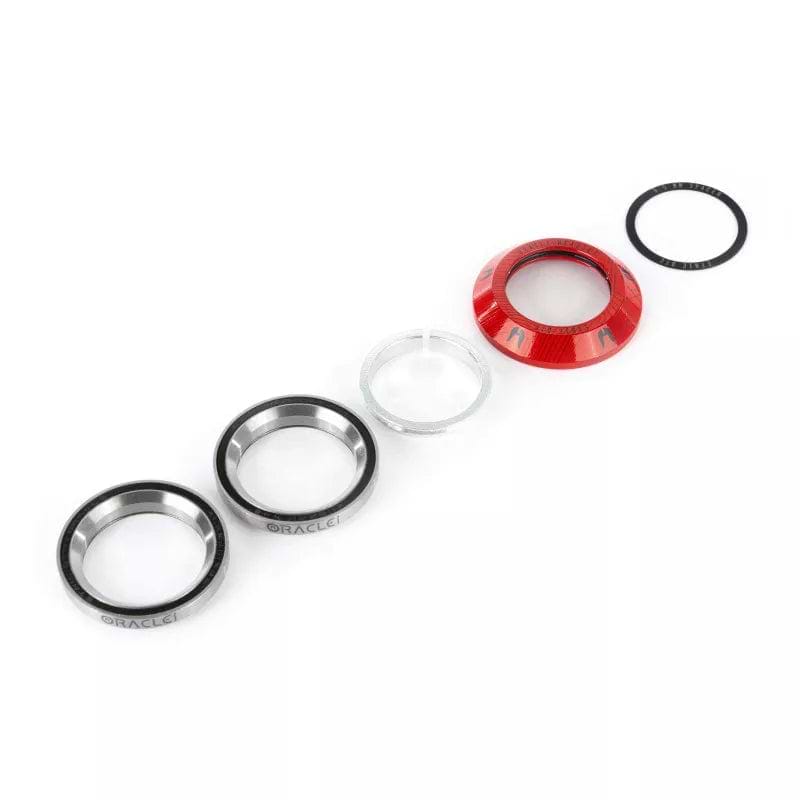 A set of Ethic DTC Oracle Integrated Stunt Scooter Headset components, perfect for smoother spinning and shock absorption during heavy landings, arranged in a line on a white background. Includes bearings, a red cap, and a small black ring.