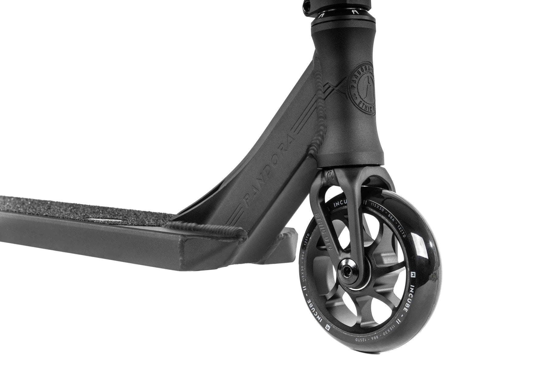 Here's a revised version of the sentence using the given product data:

Close-up of the Ethic DTC Pandora Complete Stunt Scooter (M) - Black's front wheel and deck. Engineered for street riding, it features a robust spoke design on the wheel and a deck with a textured grip surface. The scooter’s sleek contours are complemented by its durable chromoly steel T-bar, embodying Ethic's commitment to quality.