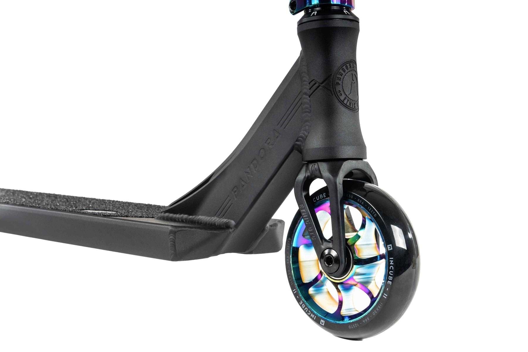 Close-up of the front wheel of the Ethic DTC Pandora Complete Stunt Scooter in neochrome, featuring a colorful and iridescent hub design. This sleek black scooter is perfect for street riding, with a textured grip tape deck and a chromoly steel T-bar neck embossed with "Pandora," highlighting its modern and stylish design.