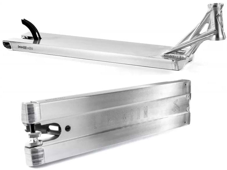 The sleek Ethic DTC Lindworm V4 Raw Silver Stunt Scooter Deck in a close-up highlights its lightweight design. This 5.9" x 21.25" deck boasts a brushed metal finish with intricate cutout details at the rear, while the Ethic brand name and logo are subtly embossed on the side.
