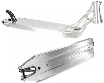 The Ethic DTC Vulcain V2 12 STD Raw Silver Stunt Scooter Deck, measuring 5.5" x 21.25", showcases a sleek silver design with geometric cut-out patterns near the handlebar area. This adaptable deck features a smooth surface and an elevated rear for added support, while the bottom is intricately engraved and equipped with a 12 STD bearing system for enhanced style and grip.