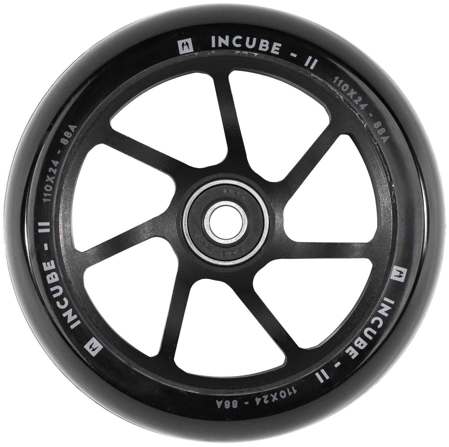 A close-up of the Ethic DTC Incube V2 110mm Stunt Scooter Wheel in black, featuring silver "Ethic" branding, "110x24 • 88A" specs on the rim, six thin spokes, and a central metal bearing.