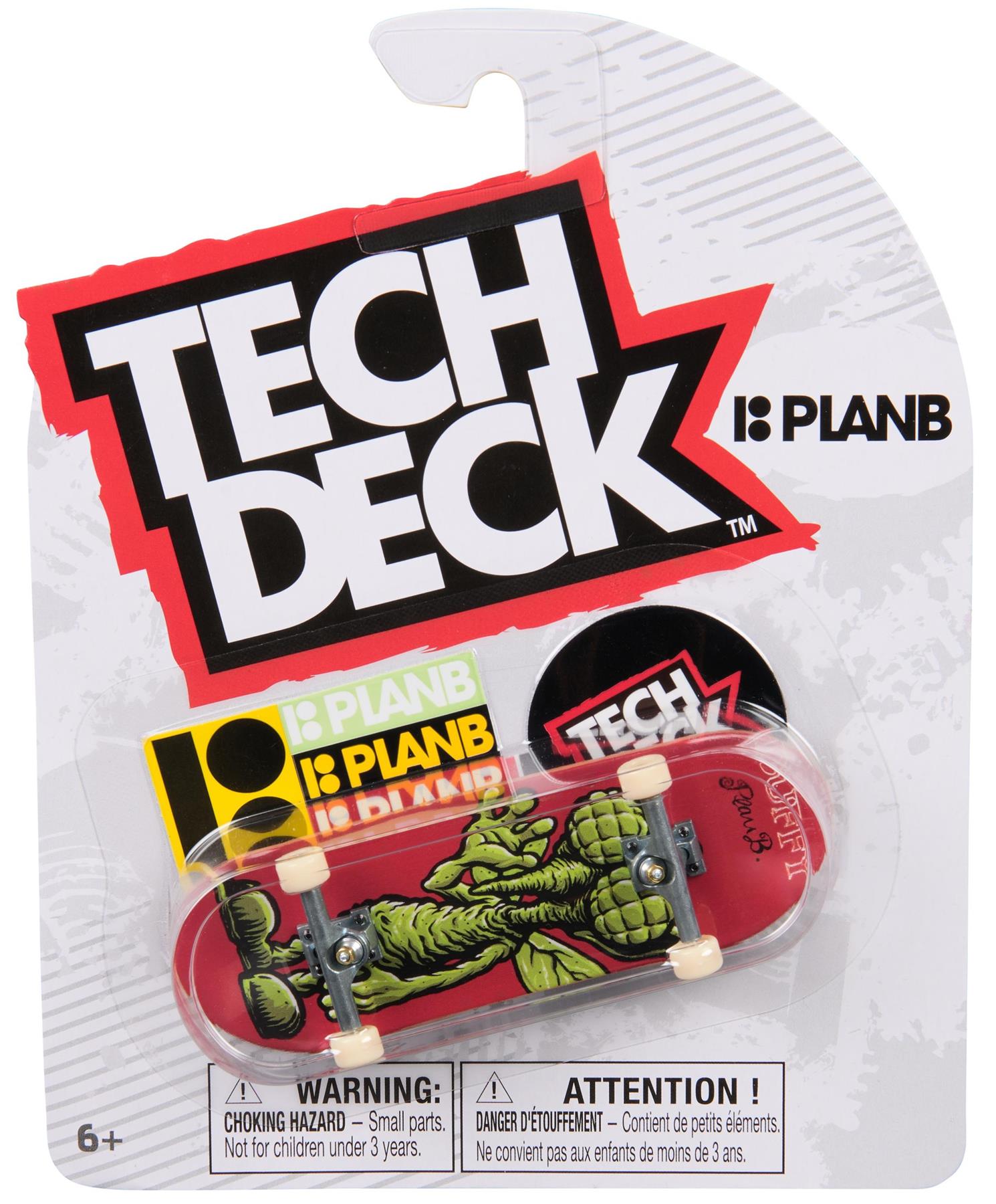 The Tech Deck 96mm M57 Fingerboard - Plan B features a red board with a green monster graphic, "Plan B" and "Tech Deck" logos, in packaging. Perfect for skateboard collectors. Suitable for ages 6 and up.