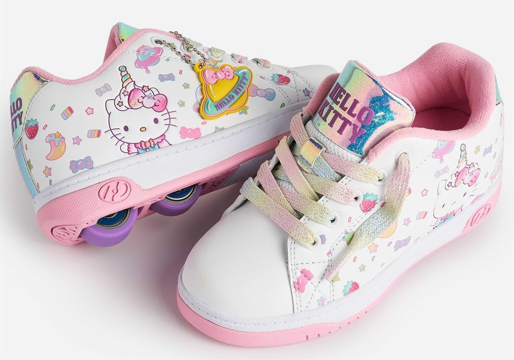 The Heelys x Hello Kitty Split X2 Girls Heelys in White/Pink feature pastel rainbow laces, a unicorn design, pink soles, purple heel wheels on one shoe, cute decorations, and a shiny Hello Kitty tongue label.