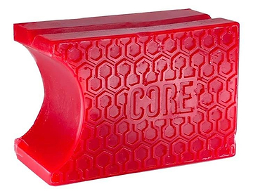 A red, rectangular rubber grip with a honeycomb pattern, featuring the word "CORE" embossed centrally, offers excellent hold enhancement for tools or sports gear. This innovative grip includes pre-grooved shapes similar to those found on CORE Epic Skate Wax - Cherry Red by CORE for superior performance.