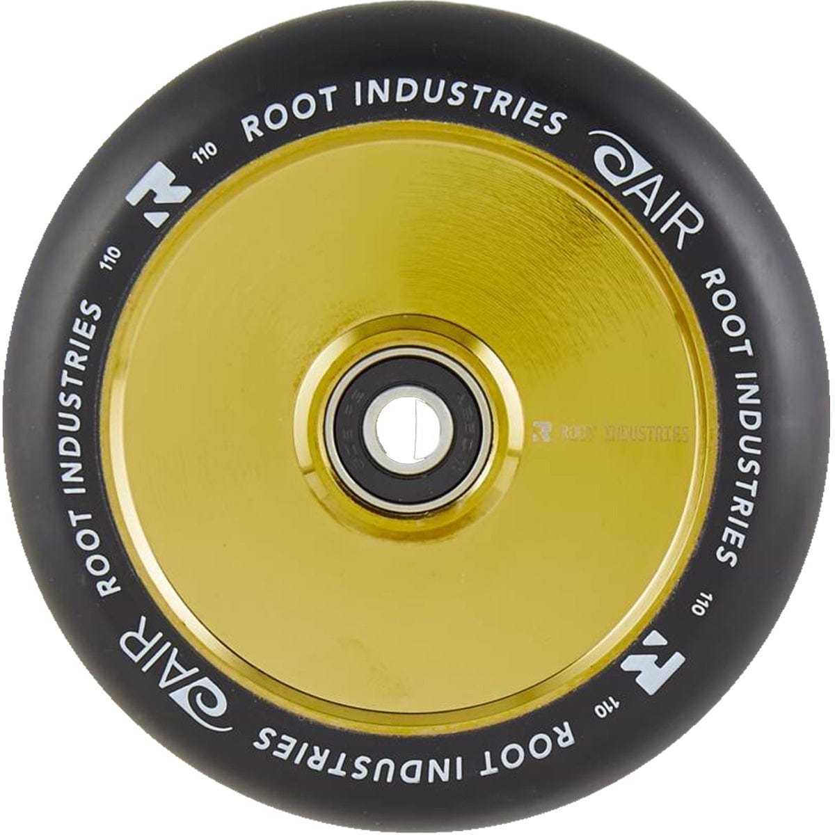 Close-up of a Root Industries AIR Hollowcore 110mm stunt scooter wheel, showcasing its shiny gold core and black outer rubber. "Root Industries" and "AIR Hollowcore" are printed in white around the edge.