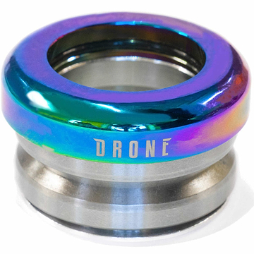 The Drone Synergy 2 Integrated Stunt Scooter Headset in Neochrome features smooth bearings and a shiny, multicolored top section with a silver base. The word "DRONE" is printed on the upper part, showcasing a reflective gradient finish that complements any integrated scooter deck.