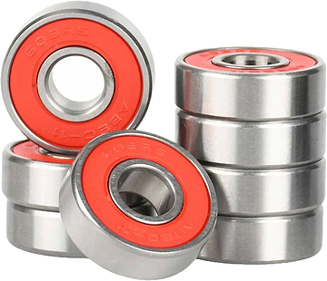 A close-up of several Ventro Ceramic ABEC 11 Red Bearings, a set of 8 skateboard bearings by Ventro, some stacked and some lying flat on a plain white background.