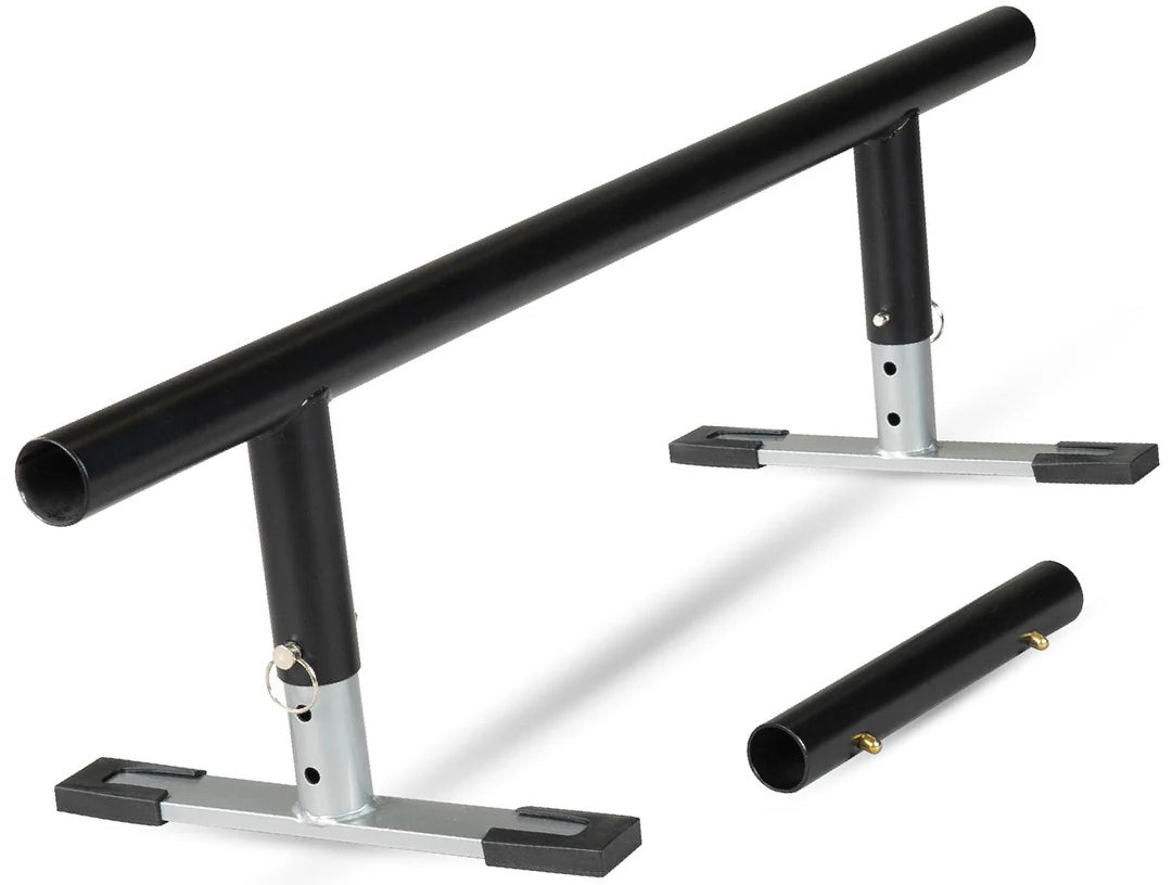 A black metal grind rail with a cylindrical bar, supported by two vertical posts on flat bases. To the right is a detachable section compatible with the Madd Gear MGP Grind Rail Extension Kit - 91cm from Madd Gear (MGP).