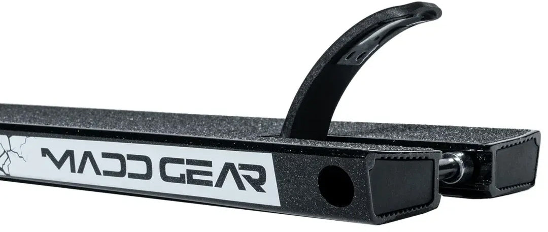 Close-up of the Madd Gear MGP MGX Black Stunt Scooter Deck—measuring 5.5″ x 20.5″—featuring grip tape, a white Madd Gear logo, and a curved rear brake, ideal for both park and street riders.