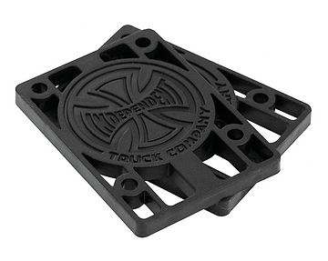 A pair of black 1/4" Independent Skateboard Riser Pads, embossed with the "Independent" logo at the center, showcases a circular design and corner holes for durability. Perfect for Indy Trucks enthusiasts who value both reliability and style.