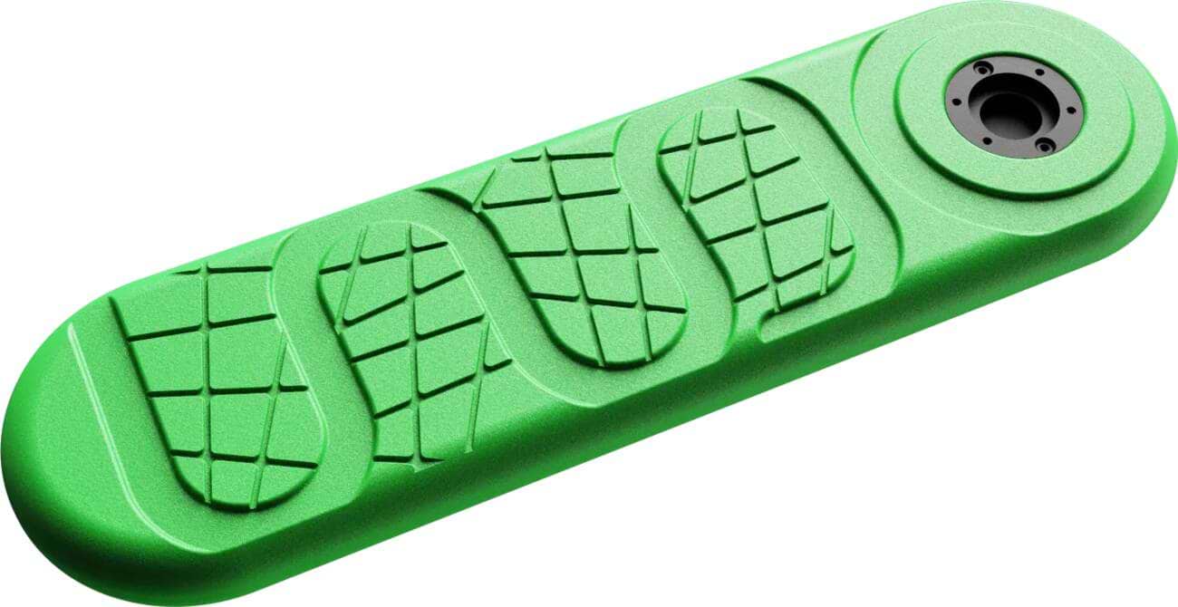 An INDO X70 Trampoline Scooter Deck called Green Gravity by INDO, featuring a green elongated design with a circular opening on one end and textured patterns resembling footprints.
