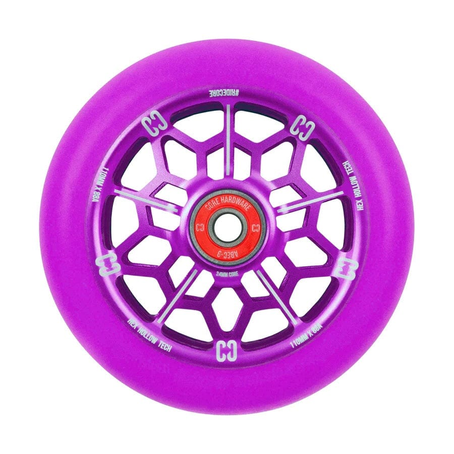 The CORE Hex Hollow Core 110mm Stunt Scooter Wheel - Purple showcases a captivating purple geometric spoke design and a bold red core. It is equipped with ABEC 9 Bearings and an 88a compound for exceptional performance. The wheel features white text encircling the edge, highlighting the CORE brand and specifications, blending style with quality.