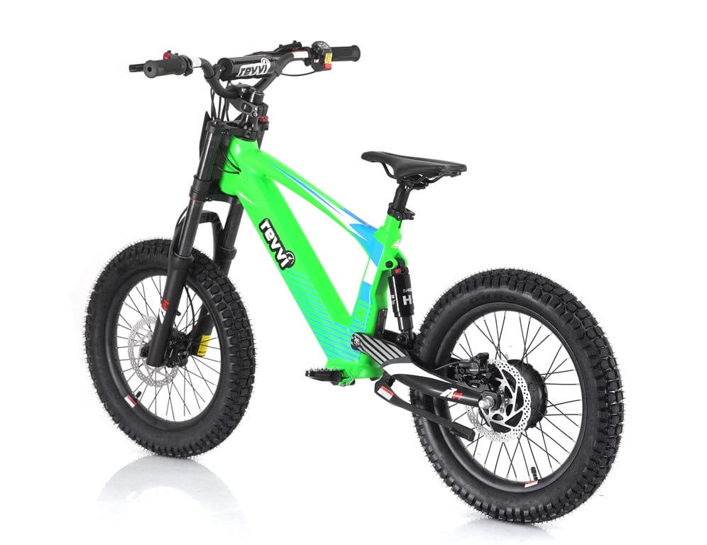 The Revvi 18" Kids Electric Balance Bike in green features thick black tires and a suspension fork, creating a striking contrast against a white background. Its modern frame is designed for efficiency and style, incorporating hydraulic disc brakes and handlebars with intuitive controls to ensure a smooth ride.