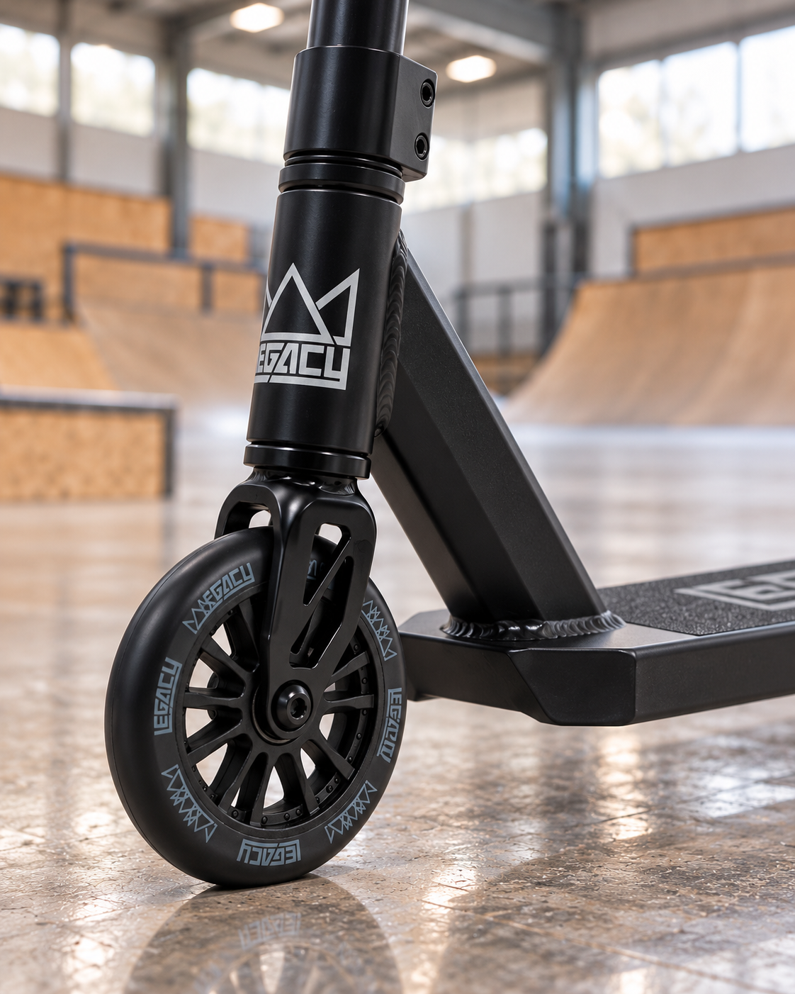 Close-up of a black Legacy Ventus 110mm Stunt Scooter Wheel, focusing on the hollow core wheel and the front fork.