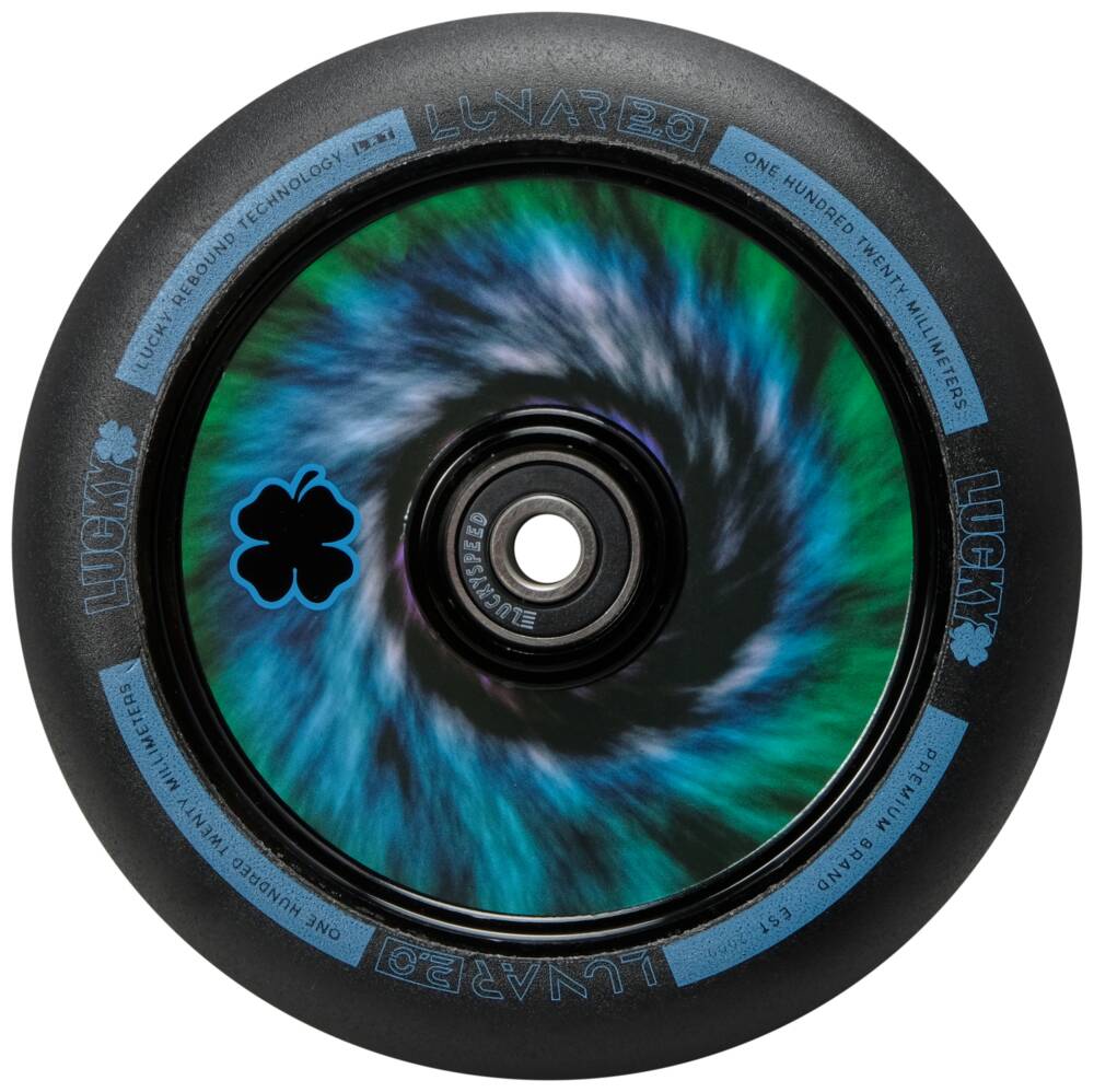 Close-up of a Lucky Lunar 110mm stunt scooter wheel in tie-dye, highlighting its swirling blue and green gradient core. The outer tire is black with "Lucky" and "Lunar 2.0" elegantly printed in light blue around the rim, showcasing Lucky Rebound Technology™ for a smooth ride.
