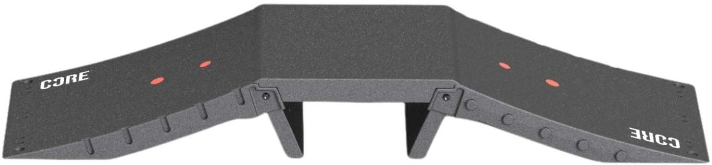 The CORE Mini Funbox Ramp Set - 2 Kickers & Flat Deck is a black plastic ramp by CORE, featuring two sloped sides, "CORE" in white on both ends, red dots, support legs under the platform, and a modular design.