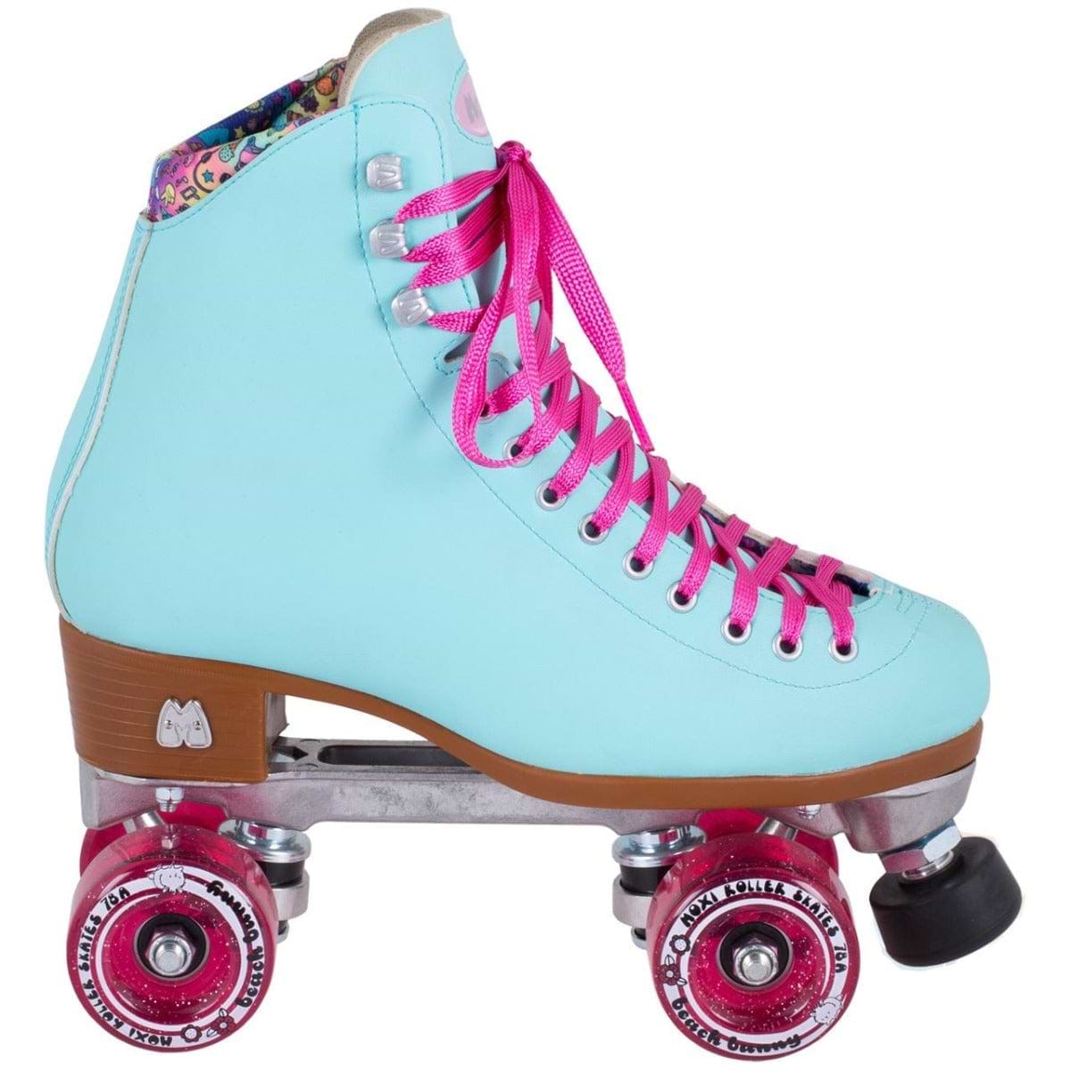 The Moxi Beach Bunny Quad Roller Skates in Sky Blue feature a vibrant turquoise design with pink laces and wheels, complemented by a floral patterned collar and a sleek wooden heel. The skates are equipped with a silver metal frame and pink toe stop, delivering a retro yet animal-friendly stylish look.