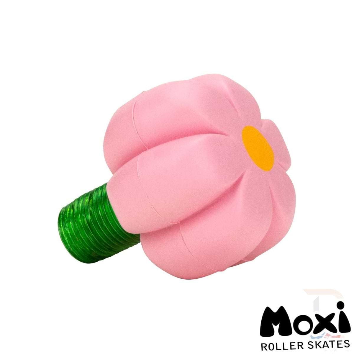 The Moxi Brake Petal Roller Skate Toe Stops - Pink Carnation are a charming pink, flower-shaped accessory complete with a green stem, expertly crafted for roller skates. Featuring the iconic Moxi logo on the bottom right corner, these toe stops add a distinctive touch to your skating gear.