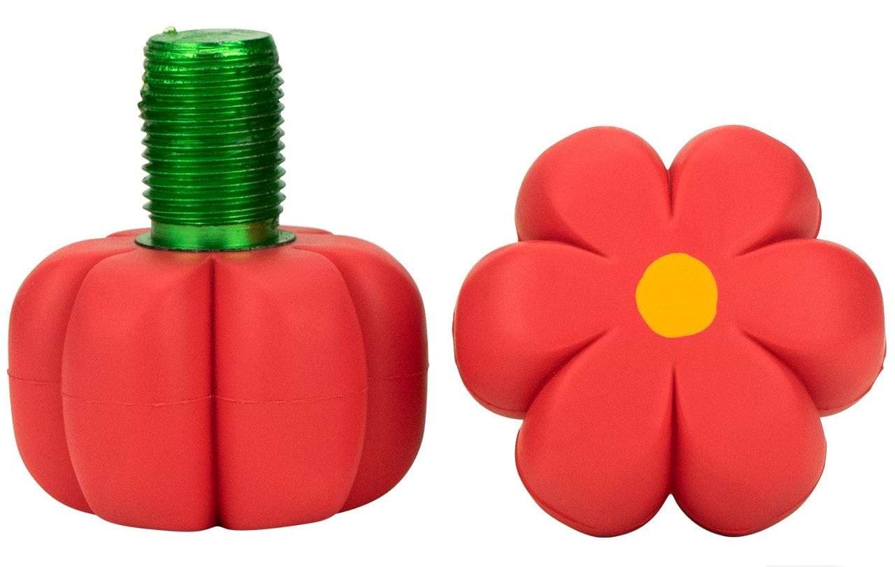 The package includes two red garden hose connectors with a whimsical, cartoon-like style: one designed to resemble a pumpkin featuring a green threaded top, and the other styled like a flower with a yellow center. Their playful appearance is similar to the Red Hibiscus design of the Moxi Brake Petal Roller Skate Toe Stops by Moxi.