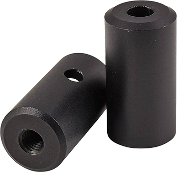 Two black cylindrical spacers, reminiscent of Native Advent Stunt Scooter Deck Ends - 140mm by Native, one lying down and one standing upright. Each aluminum spacer features a central threaded hole and a side hole. The objects are placed on a pristine white background.