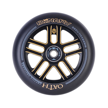 Close-up of the lightweight Oath Binary 110mm Stunt Scooter Wheel, featuring sleek black and orange accents. Displaying "BINARY" and "OATH," this wheel is specified as "88DU" with dimensions of "110x24MM," and comes equipped with Oath Fidelity bearings for improved impact resistance. The central hub exhibits intricate design details.