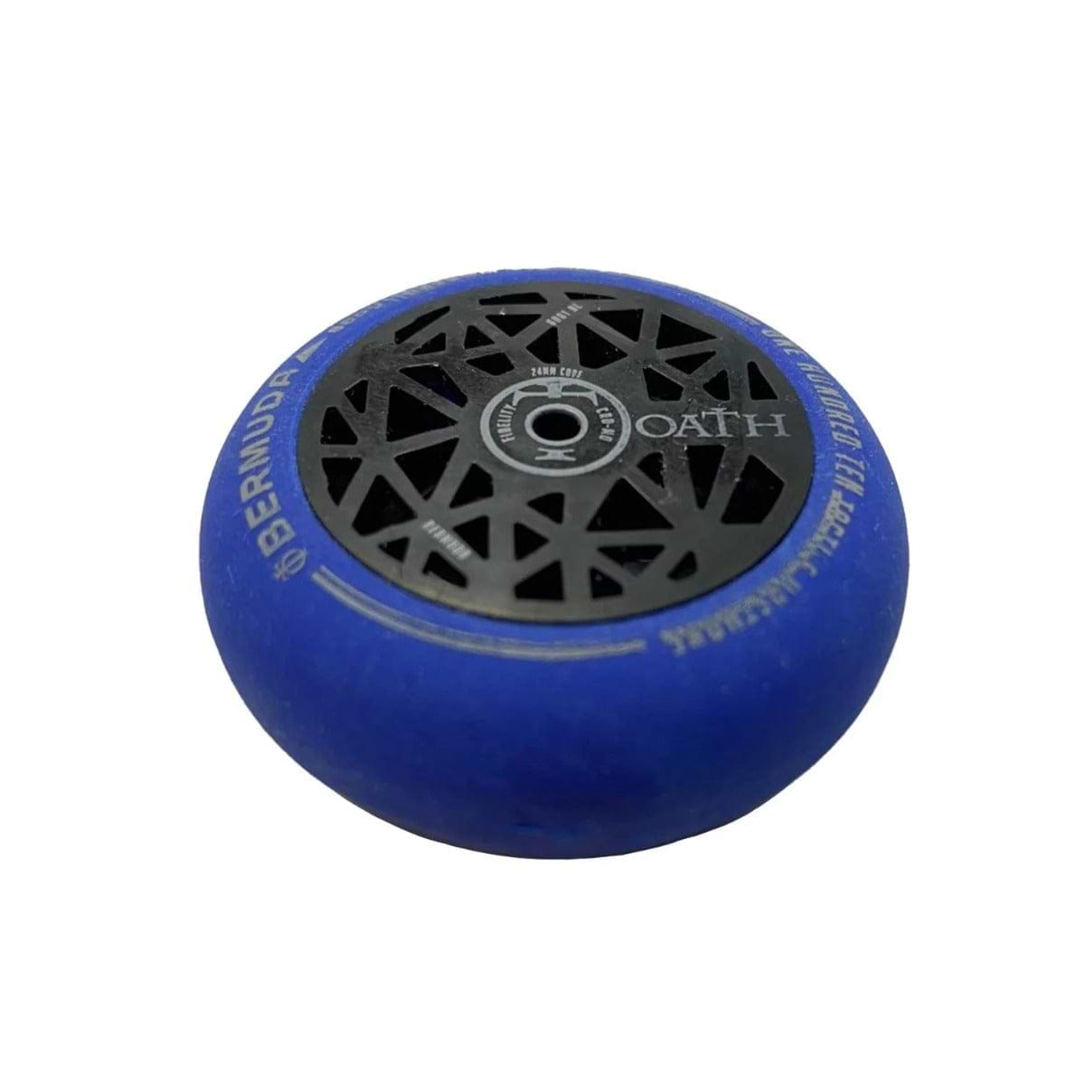Ideal for scooter enthusiasts, the Oath Scooter Wheel Eraser - Blue by CORE features a sleek black core with geometric cutouts and the brand name "Oath" prominently displayed at the center. The tire's edge is elegantly inscribed with "Bermuda" in purple.