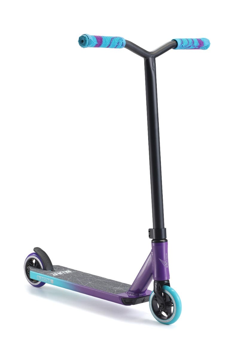 Introducing the Blunt Envy ONE S3 Complete Stunt Scooter in Purple and Teal—ideal for beginners! It features a sleek black T-bar handle, durable professional scooter components including blue hand grips and deck. The scooter is designed with a blue front wheel and black rear wheel, perfect for tricks and freestyle riding.