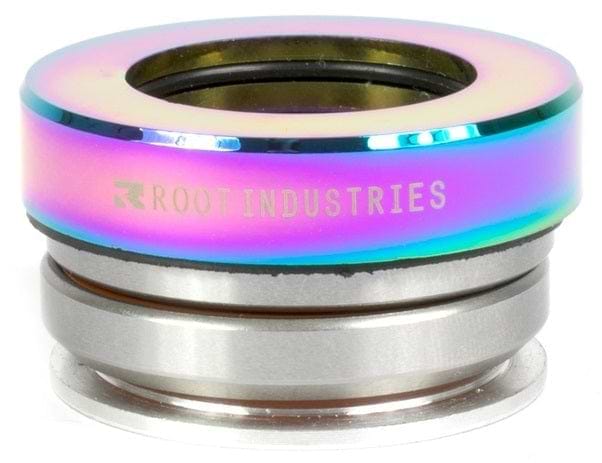 The Root Industries Integrated Stunt Scooter Headset - Rocket Fuel Neochrome displays a vibrant multi-color neochrome finish with metallic hues and branded text on its outer ring. Equipped with high-quality sealed bearings, it upholds the sleek design associated with premium scooter components from Root Industries.
