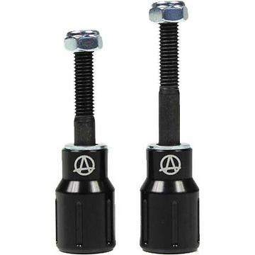 Two black Apex Barnaynay motorcycle bar end sliders with silver bolts on top. The sliders display a logo featuring an "A" inside a circle. They vary in height, one slightly taller than the other, reflecting Kiall Barnes's design precision.