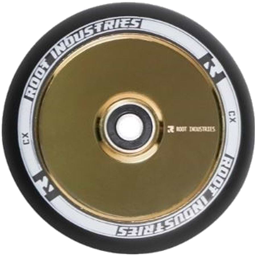 A close-up of the Root Industries AIR Hollowcore 120mm stunt scooter wheel highlights its gold metal core, black tire, and white detailing. The wheel showcases Root Industries' hollowcore technology with the brand name "ROOT INDUSTRIES" elegantly printed on the rim.