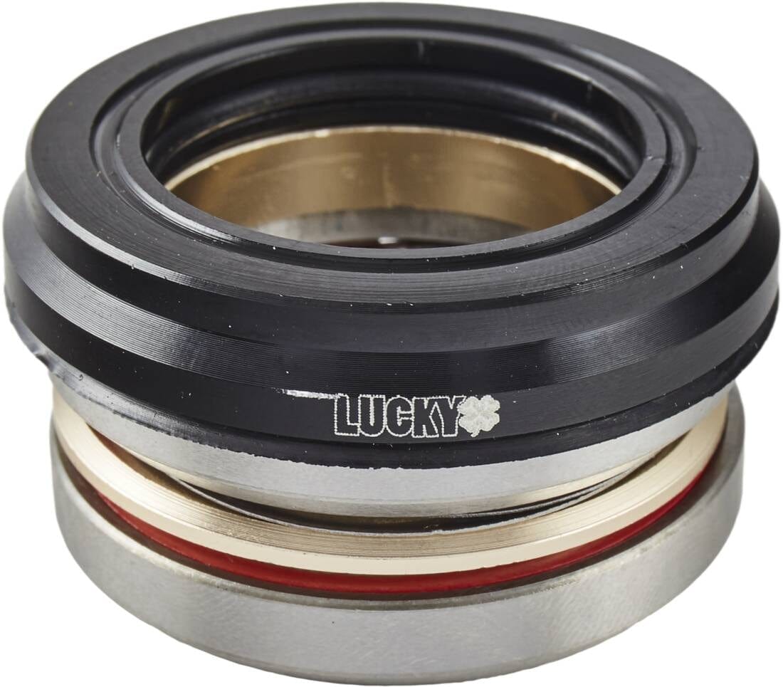 Close-up of the sturdy Lucky Revo Integrated Stunt Scooter Headset in black, featuring a sleek design with silver and red rings. The brand name "LUCKY," along with a small star symbol, is prominently displayed in white on the top section. This integrated scooter component guarantees smooth and stylish rides.