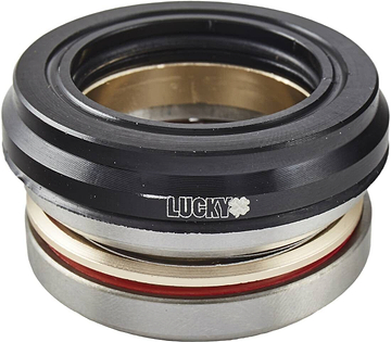 Close-up of the sturdy Lucky Revo Integrated Stunt Scooter Headset in black, featuring a sleek design with silver and red rings. The brand name "LUCKY," along with a small star symbol, is prominently displayed in white on the top section. This integrated scooter component guarantees smooth and stylish rides.