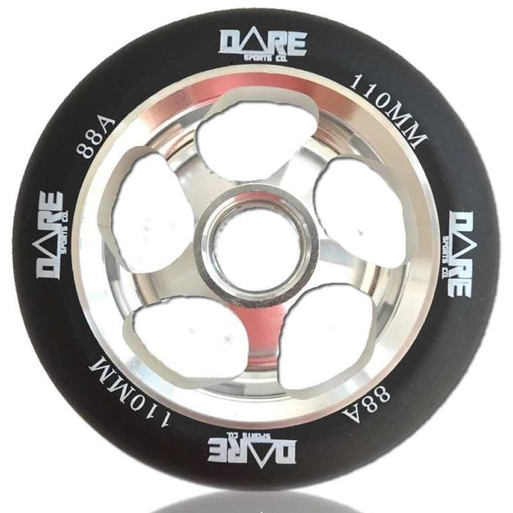 Close-up of the Dare Motion 110mm Stunt Scooter Wheel, showcasing a black tire with "DARE" branding. It features a silver metallic aluminum core with five large cutouts for a sleek and lightweight design. The polyurethane tire is specified as 110MM with an 88A hardness rating.
